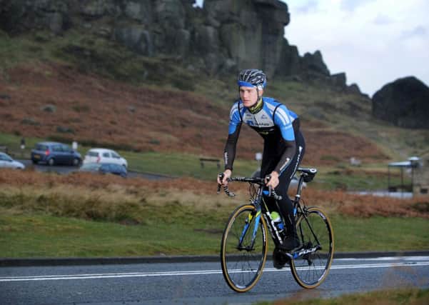 Scott Thwaites, from Burley in Wharfedale, rides past the Cow and Calf Rock above Ilkley.  (Picture: Bruce Rollinson)