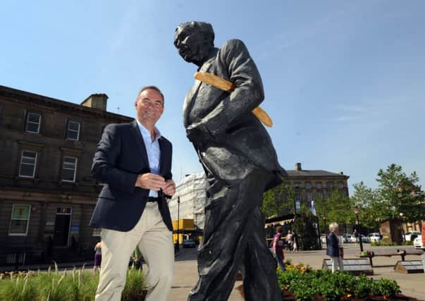 Bernard Hinault by the Harold Wilson statue outside Huddersfield railway station