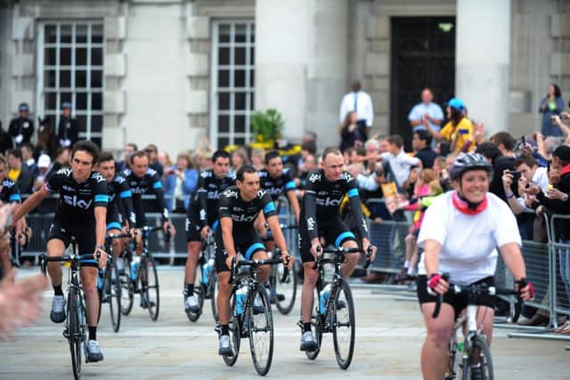 Chris Froome (right) leads Team Sky past during the team presentation in Millennium Square, on their way to The Leeds Arena, Leeds.
2nd July 2014. Picture Jonathan Gawthorpe.