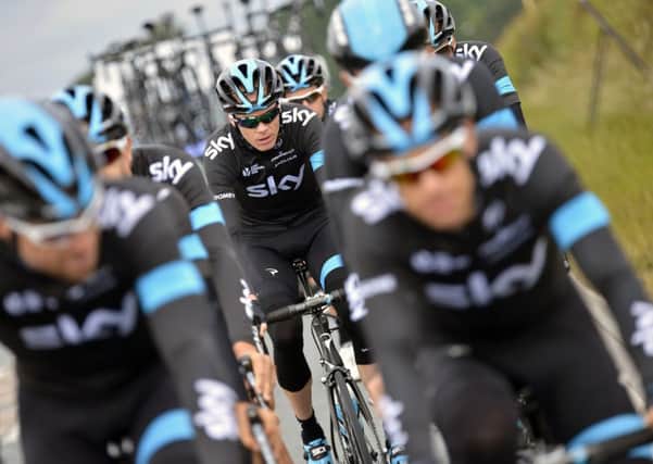 Tour de France title holder Chris Froome is flanked by his Team Sky colleagues during a training session in Leeds yesterday before the start of the 101st edition of the Tour (Picture: AFP Photo/Jeff Pachoud).