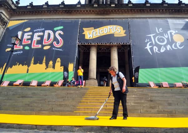 Pauline Margereson vacs the yellow carpet outside Leeds Town Hall ready for the start of the Tour de France in Leeds.  Picture by Tony Johnson