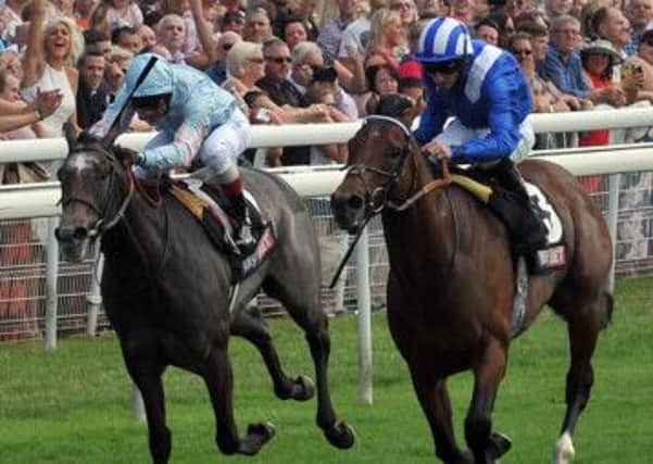 Paul Hanagan on Mukhadram, right, on their way to winning the York Stakes last year (Picture: Mike Cowling).