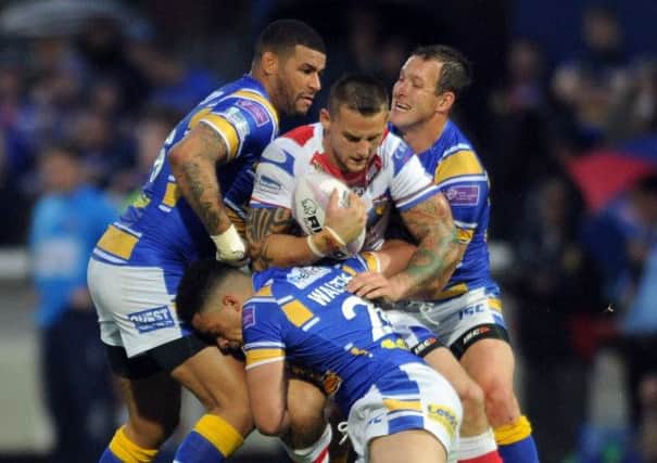 Wildcats try scorer Richard Owen is tackled this time by Brett Delaney Josh Walters and Danny McGuire.