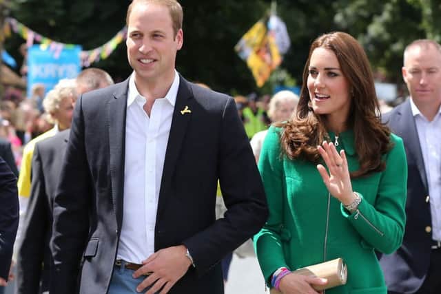 The Duke and Duchess of Cambridge wave to the crowds gathered to celebrate the start of the Tour de France in Yorkshire at West Tanfield.