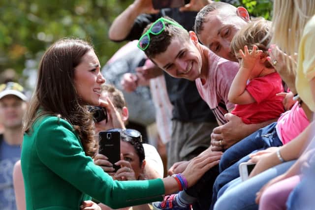 The Duke and Duchess of Cambridge wave to the crowds gathered to celebrate the start of the Tour de France in Yorkshire at West Tanfield.