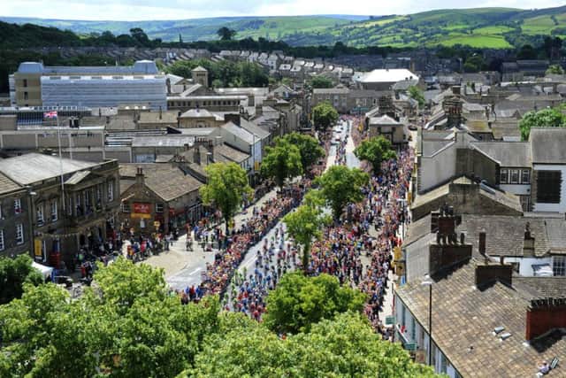 The Tour de France cyclists make their way up Skipton High Street, having left Ilkley