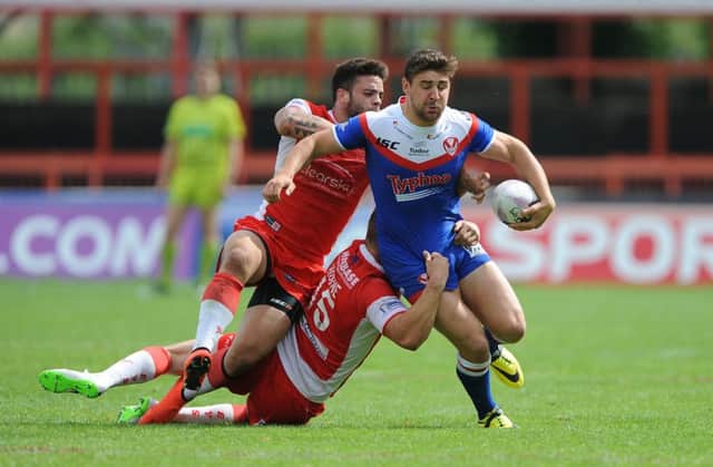 St Helen's Tom Makinson is tackled by Hull KR's Kevin Larroyer (left) and Graeme Horne.