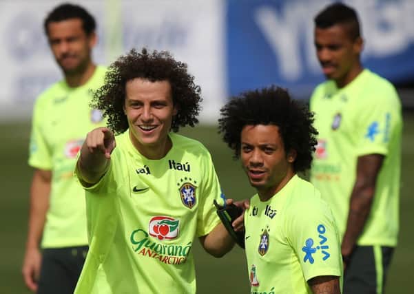 Brazil's David Luiz, left, talks to Marcelo during a practice session.