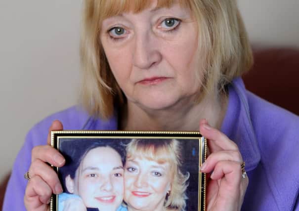 Linda Umpleby holds a picture of her missing daughter Gemma Simpson