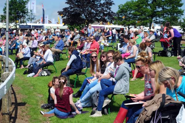 Crowds relax in the sunshine by the main ring at the Great Yorkshire Show, Harrogate.