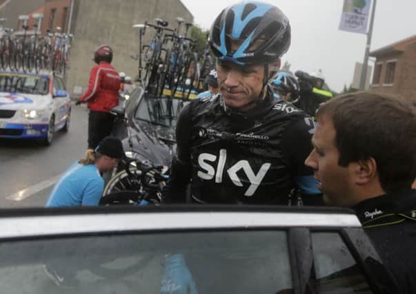 Britain's Christopher Froome gets into his team car after abandoning the race following a third consecutive crash in two days during the fifth stage of the Tour de France.