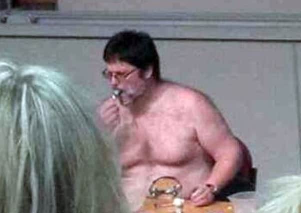 Pictures on Twitter appear to show 51-year-old Dr Ian Lamond sitting shirtless behind a desk.