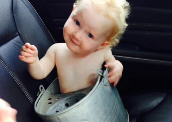 16 month old Minnie Snodgrass got stuck in a metal mop bucket. Picture: Ross Parry Agency