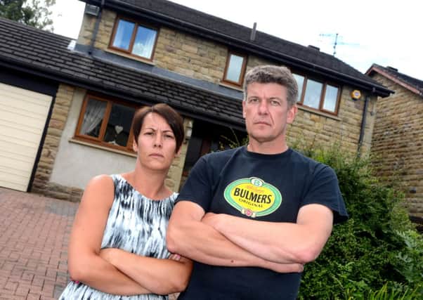 Paul Beaumont and his wife Alison outside their home in Liversedge.