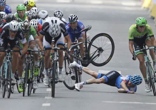Andrew Talansky of the U.S. crashes as the pack with stage winner Italy's Matteo Trentin, foreground left, sprints towards the finish line during the seventh stage of the Tour de France cycling race over 234.5 kilometers (145.7 miles) with start in Epernay and finish in Nancy, France. (AP Photo/Peter Dejong)