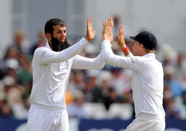 England's Moeen Ali (left) celebrates with Joe Root after taking the wicket of India's Stuart Binny during day five of the first Investec test match at Trent Bridge, Nottingham.