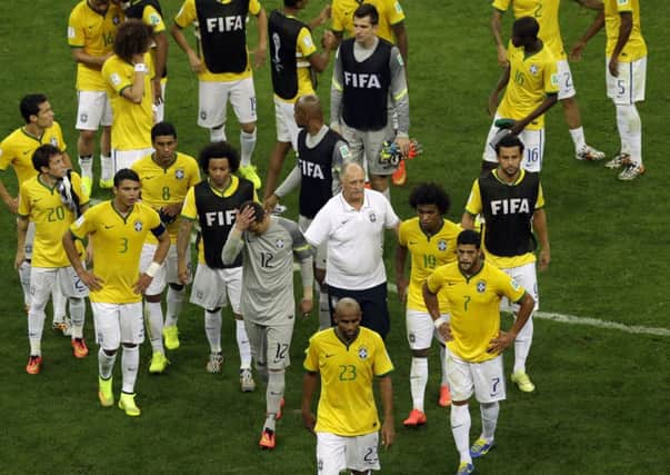 Brazil's coach Luiz Felipe Scolari with his demoralised players after defeat to the Netherlands.