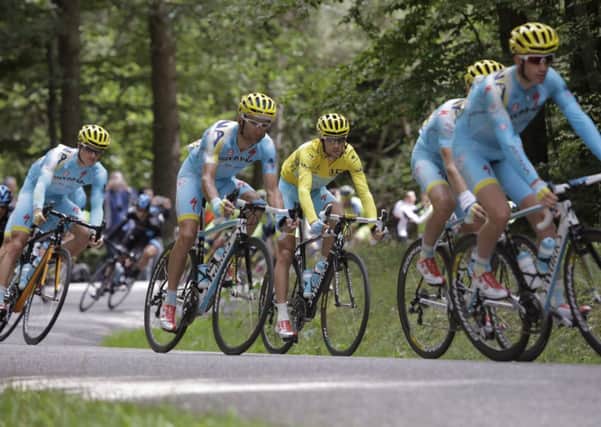 Italy's Vincenzo Nibali, wearing the overall leader's yellow jersey, center, and Denmark's Jakob Fuglsang, left, lead the chase of the pack after the breakaway group during the ninth stage of the Tour de France cycling race over 170 kilometers (105.6 miles).. (AP Photo/Laurent Cipriani)