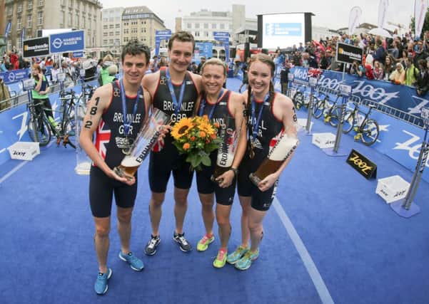 The winning team from Britain, left to right,  Jonathan Brownlee, Alistair Brownlee, Vicky Holland and Lucy Hall. (AP Photo/dpa,Axel Heimken)