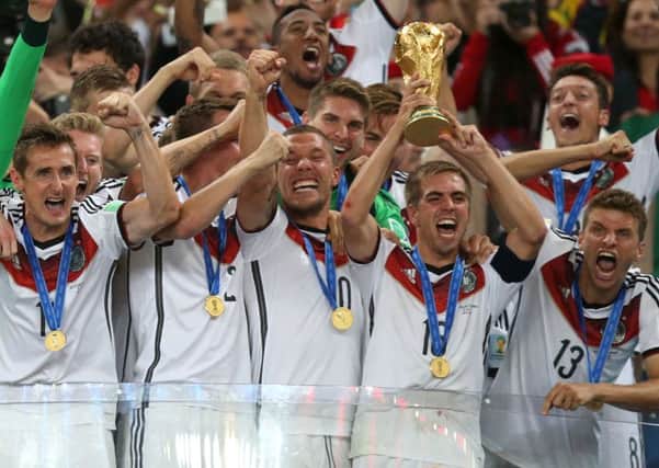 Germany's Philipp Lahm lifts the World Cup and celebrates victory with team-mates after the FIFA World Cup Final at the Estadio do Maracana, Rio de Janerio, Brazil.
