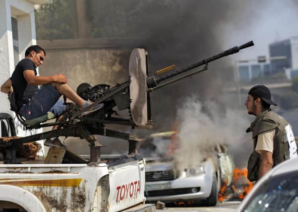 Libyan rebel fighters prepare to shoot towards pro-Gadhafi forces during fighting in Tripoli