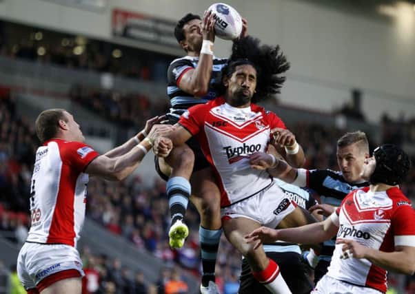 London Broncos' Denny Solomona, pictured battling St Helens Sia Soliola, is to join Castleford Tigers.