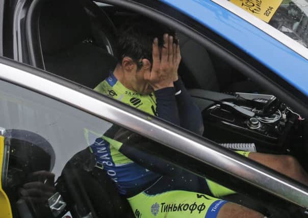 Spain's Alberto Contador covers his face as he abandons the race.