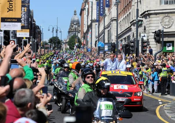 Cyclists race down the Headrow at the Start of the Tour De France. Picture by Simon Hulme
