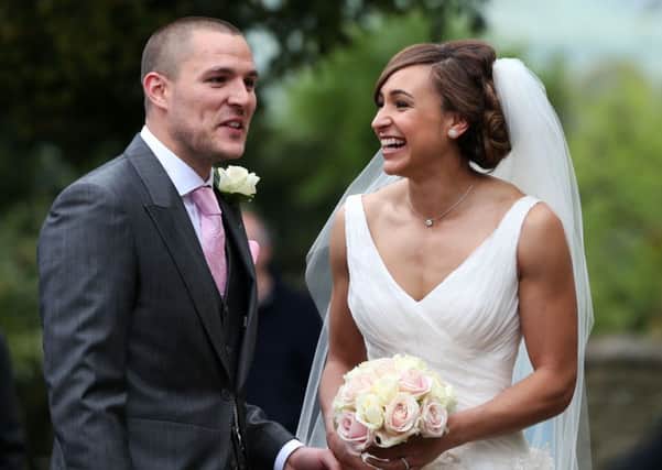 Jessica Ennis poses for the waiting media after she married Andy Hill in St Michael and All Angels Church, Hathersage, Derbyshire.