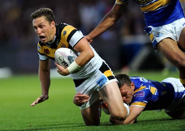 Tigers' Luke Dorn is tackled by Rhinos' Kevin Sinfield.