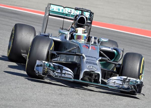 Mercedes Formula One driver Lewis Hamilton of Great Britain speeds during the free practice session at the German Formula One Grand Prix in Hockenheim. (AP Photo/Jens Meyer)