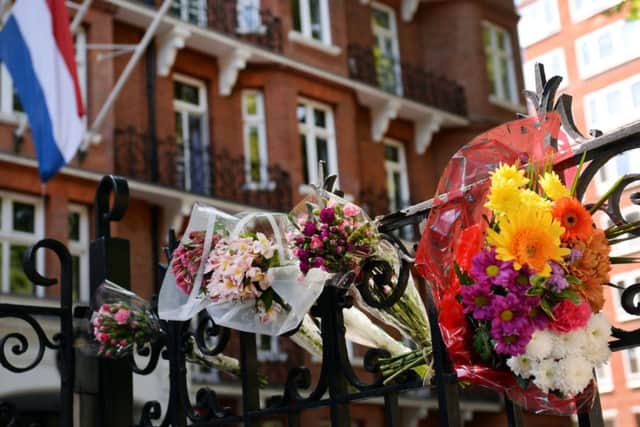 Flowers are laid outside the Dutch Embassy in London