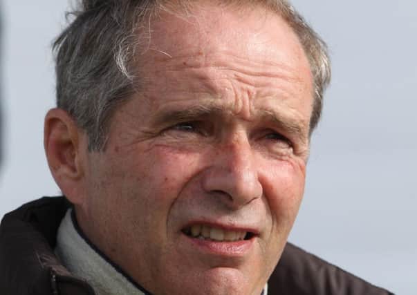 Andre Fabre, trainer for Pour Moi watches his horse on the gallops during the Breakfast with the Stars at Epsom Racecourse.