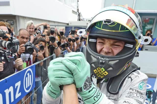 Mercedes driver Nico Rosberg of Germany celebrates winning the German Formula One Grand Prix in Hockenheim. (AP Photo/Jens Meyer)