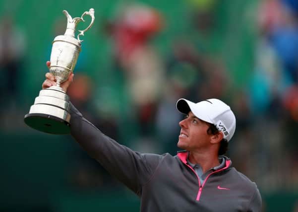 Northern Ireland's Rory McIlroy celebrates with the Claret Jug.