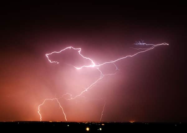 Lightning strikes as the UK is now braced for torrential downpours and storms that will could cause flash flooding across large parts of the country