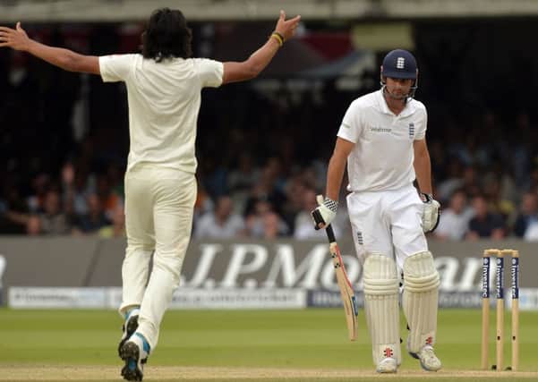 England's Alastair Cook is caught behind by India's MS Dhoni off the bowling of Ishant Sharma