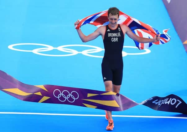 Alistair Brownlee celebrates as he crosses the finish line at London 2012.