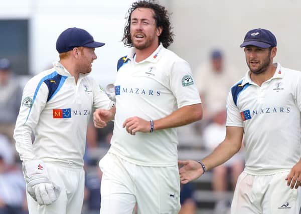 Yorkshire's Ryan Sidebottom (centre) is congratulated by Jonny Bairstow (L) and Tim Bresnan (R) on the wicket of Middlesex's Toby Roland-Jones.
