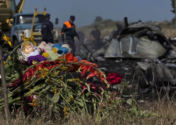 Toys and flowers are placed at the crash site of Malaysia Airlines Flight 17 near the village of Hrabove, eastern Ukraine