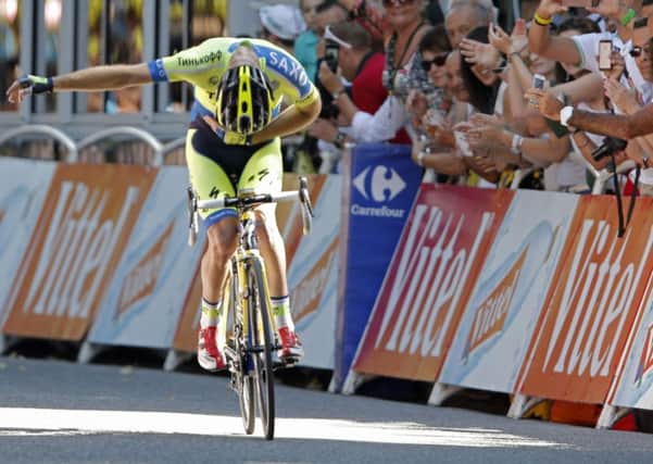 Australia's Michael Rogers bows for cheering spectators as he crosses the finish line to win the sixteenth stage of the Tour de France . (AP Photo/Peter Dejong)