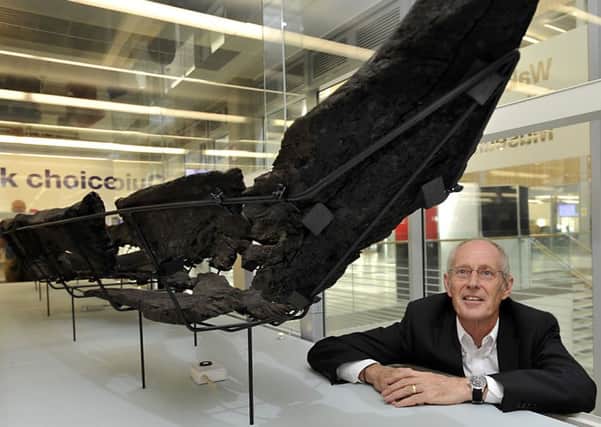 Council Leader Peter Box with the remains of the Viking boat