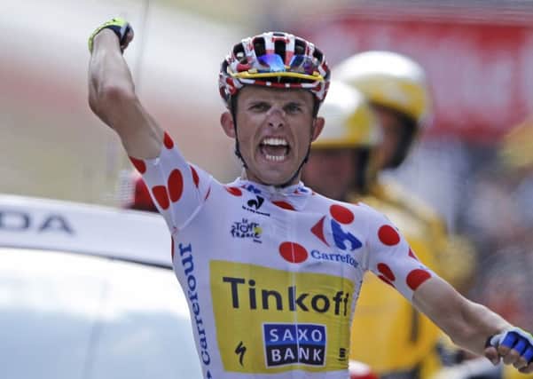 Poland's Rafal Majka crosses the finish line to win the 17th stage of the Tour de France.