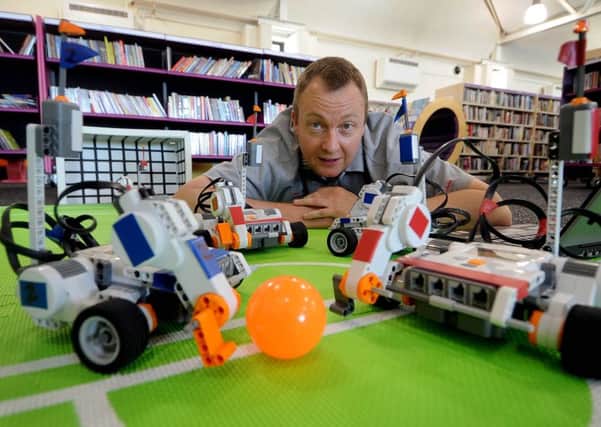 Andrew Amos, from Riveting Robots, with some of the Lego Football Units, controlled via a laptop. PIC: James Hardisty