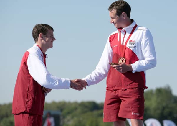 Alistair Brownlee (right)  is congratulated by his brother Jonathan after winning the Men's Triathlon.