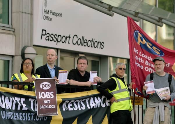Workers outside the HM Passport office in London