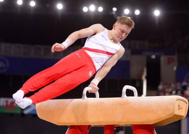 England's Nile Wilson competes on the pommel horse during the Men's Team Final and Individual Qualification at the SEE Hydro, during the 2014 Commonwealth Games in Glasgow.