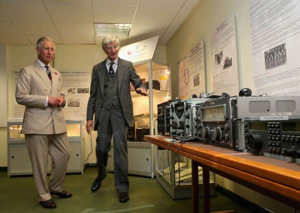 The Prince of Wales tries out an WWII Enigma coding machine in the museum of GCHQ Scarborough