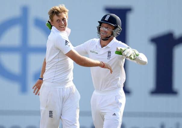 Yorkshire's Joe Root, left, celebrates with team mate Jos Buttler after taking the wicket of India's Shikhar Dhawan.