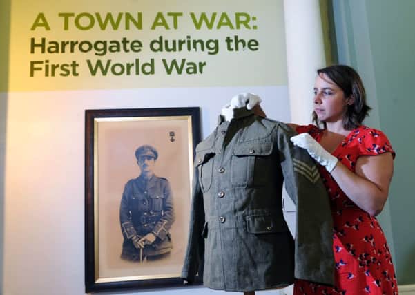 Legacies of War: Acting social history curator Nicola Baxter in front of a photograph of Donald Simpson Bell VC, also circled, at the Harrogate during the First World War exhibition at The Royal Pump Room Museum. Picture: Jonathan Gawthorpe.